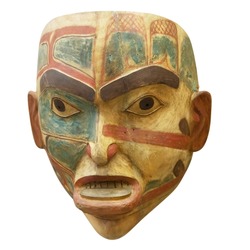 A lively wooden carving face on a totem pole by ancient native indian american, Victoria, British Columbia, Canada isolated on white background with clipping path