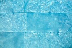 Ice block wall as texture or background. Cold frost transparent bricks pattern