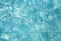 Ice block wall as texture or background. Cold frost transparent bricks pattern