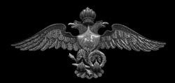 Russian double-headed coat of arms eagle, made from triggers, spherical bullets, and lock planks from flintlocks isolated on black background with clipping path