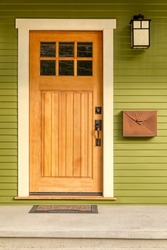 Arts and Crafts style wooden front door entrance to home
