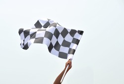 checkered race flag in hand.
