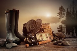 Fly fishing equipment on deck with view of a misty lake background