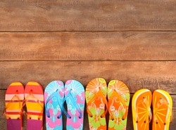 Brightly colored flip-flops on wood