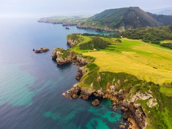 Aerial photos of the coast of the Cantabrian Sea in the north of Spain. In it you can see the coast and the meadows that next to the cliffs. The photos were taken in the town of Pechón.