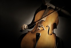 Cello player. Cellist hands playing violoncello orchestra music instrument closeup