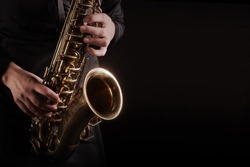 Saxophone Player hands Saxophonist playing jazz music. Alto sax musical instrument closeup