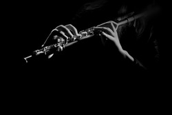 Flute instrument closeup Flutist hands playing flute music isolated on black background