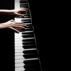 Piano player. Pianist playing musical instrument close up. Grand piano with hands closeup