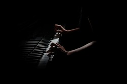 Piano player. Pianist hands playing grand piano keys. Music instrument close up