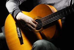 Acoustic guitar guitarist playing details. Musical instrument with performer hands