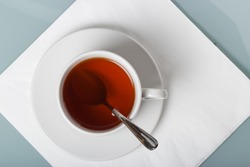 A cup of tea on a napkin. The geometric composition with copy space.