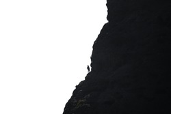 Long shot of climbers hanging by a cliff against white, high contrast