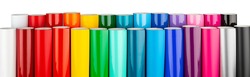 Row of various rainbow colored vinyl car wrapping or plotter cutting sticker foil film rolls isolated on white wide panorama banner background