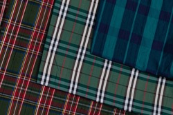 Collection of Scottish fashionable fabrics . Samples of different natural fabrics for sewing a fashion collection of clothes. Large selection of fabrics in the store or tailor warehouse.