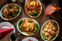 Spread of Chinese food on a table with drinks
