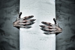 A Pair of Scary Hands Reach Out from Behind a COlumn