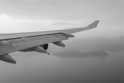 Wing of an airplane flying above the sea near Hong Kong
