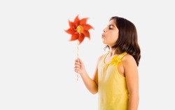 Beautiful girl blowing a plastic windmill