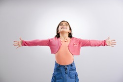 Little girl looking up with both arms open