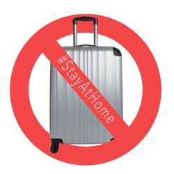 Silver Suitcase on a white background with international no symbol and #stayathome. Cancelled trip tourism restrictions concept during COVID-19 pandemic. 
