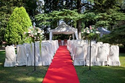Red carpet and chairs for an outdoor wedding