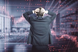 Back view of stressed young european businessman standing in blurry office interior with falling red index candlestick graph. Crisis, market fall, recession and money loss concept. Double exposure