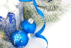 Christmas accessories in blue & fir tree branch on white