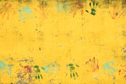 Set of colorful hand prints on bright yellow wall
