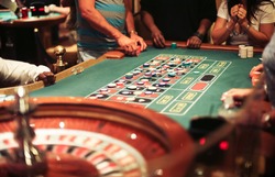 Group of people on the casino roulette playing
