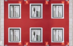 Six vintage windows on a bright red wall. Exterior facade of red historical house with apartments in Lisbon, Portugal. Urban vintage background
