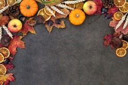 Autumn nature background border with food, flora and fauna on lokta paper background. Top view. Harvest festival, Thanksgiving and Halloween  theme.
