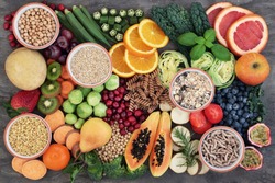 Vegan health food concept for  high fibre diet with fruit, vegetables, cereals, whole wheat pasta, grains, legumes, herbs. Foods high in antioxidants  and vitamins. Immune system boosting. Flat lay.