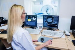 Radiologist in the control room of computed tomography at hospital