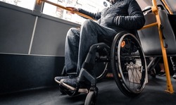Person with a physical disability inside public transport with an accessible ramp.
