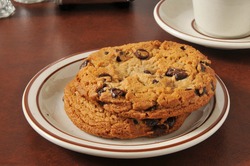 A plate of thick, gourmet chocolate chip cookies