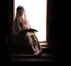 Young adult jewish arab ethnic alone human scarf veil cloth devote old life hope light dark black door backdrop page view text space. Sad lone pretty islam arabian white lady face hous seat stair step