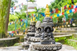 Several small stone stupas in a row in Swayambhunath temple, also called Monkey Temple. Kathmandu city, travel in Nepal concept.