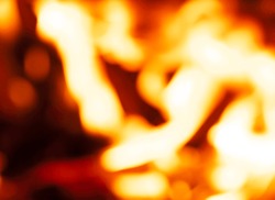 Colorful bokeh fire flames as abstract background. Photo out of focus.