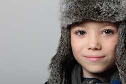 Winter fur hat clothing boy on grey background