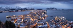 Evening panorama of the snowy city of Alesund in illumination in Norway
