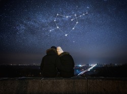 Valentines Day card. Couple in love looking at stars. Night in city. Constellation in shape of a heart