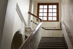 Stair inside a old building, leading to a window