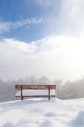 red bench empty desolate winter landscape