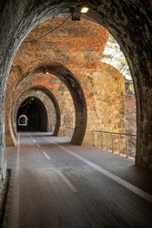 Cycle path in Liguria built on the old train route. Tunnel made from red bricks. Nobody inside