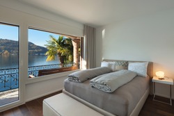 Nice bedroom with large window, view of the lake