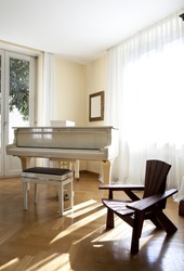Interior house, nice livingroom piano and chair