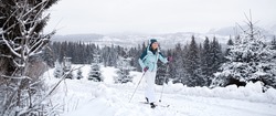 Happy mid adult woman  skiing outdoors in winter nature, Tatra mountains Slovakia.