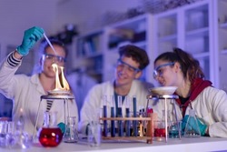 Science students doing chemical experiment in the laboratory at university.