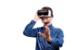 Man wearing virtual reality goggles. Studio shot, white backgrou
